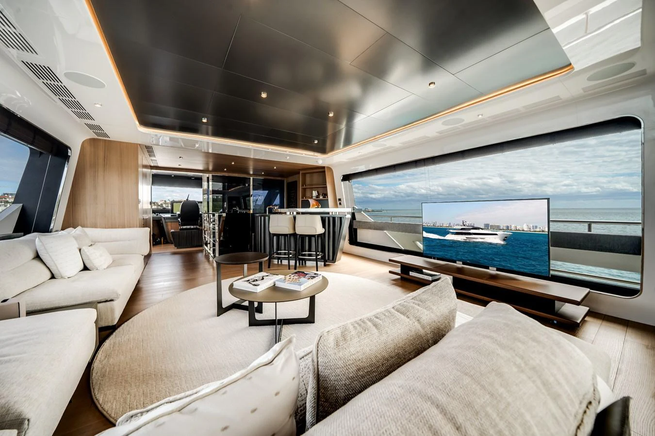 The salon features luxurious seating, a large flat-screen TV, and expansive windows offering stunning ocean views. aboard OCEAN ALEXANDER 35P05 Yacht for Sale