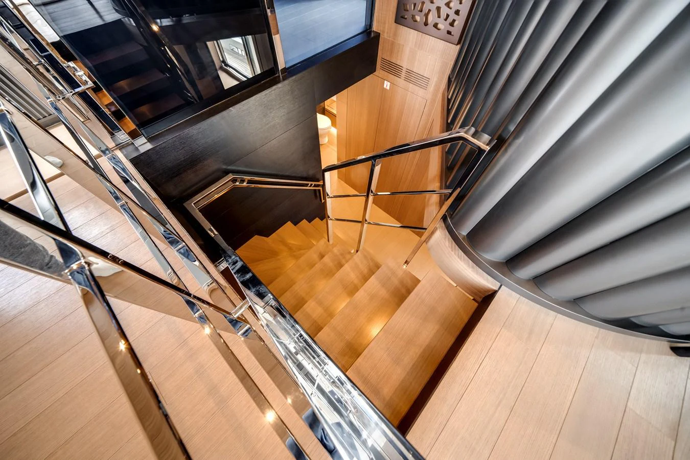 A sleek and modern staircase with polished railings and wooden steps. aboard OCEAN ALEXANDER 35P05 Yacht for Sale