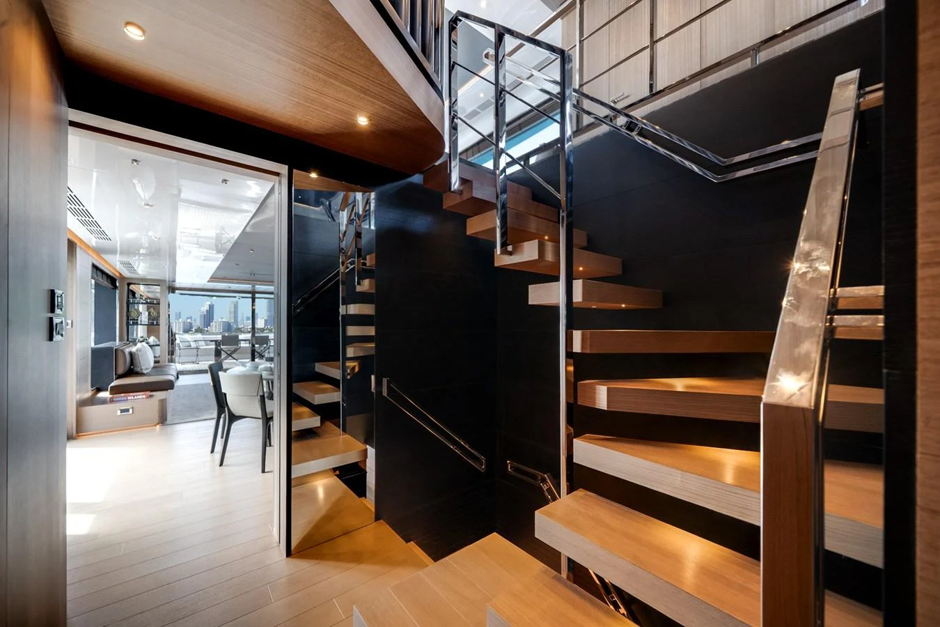A modern staircase with wooden steps and sleek railings leads to the upper deck of the yacht. aboard OCEAN ALEXANDER 35P05 Yacht for Sale