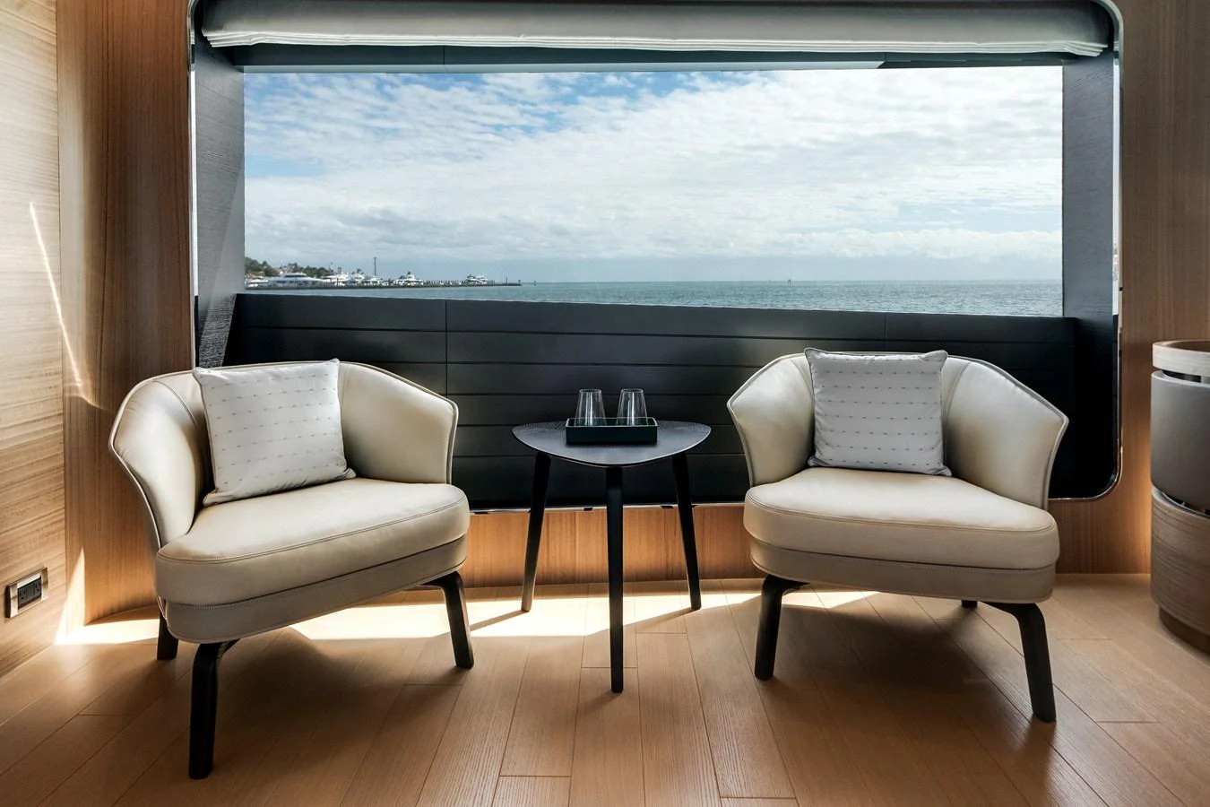 A serene seating area with a stunning ocean view through a large window. aboard OCEAN ALEXANDER 35P05 Yacht for Sale