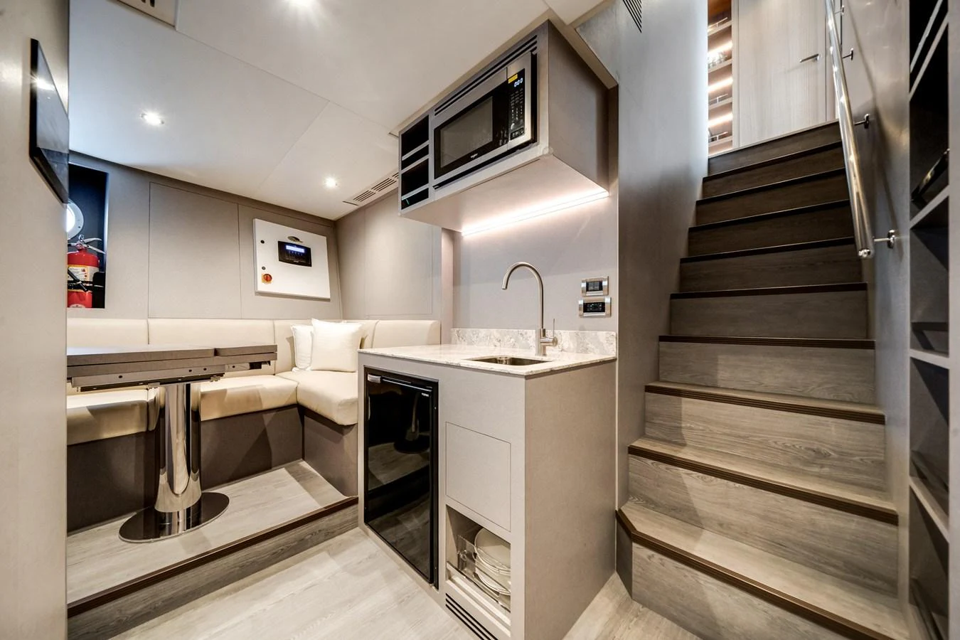 The yacht's interior features a modern galley with a dining area and a staircase leading to the upper deck. aboard OCEAN ALEXANDER 35P05 Yacht for Sale