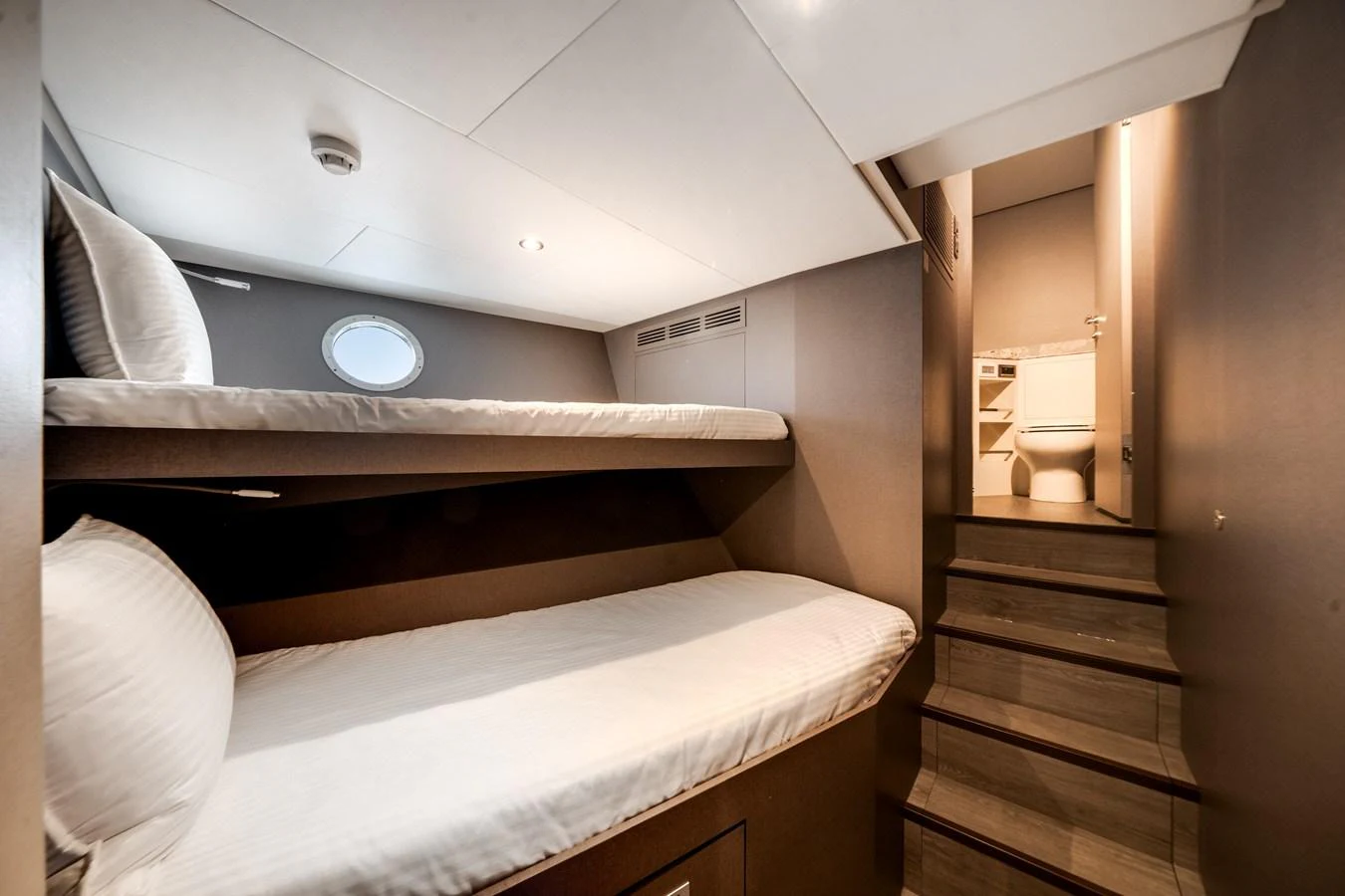 The cozy guest cabin features bunk beds and leads to an en-suite bathroom. aboard OCEAN ALEXANDER 35P05 Yacht for Sale