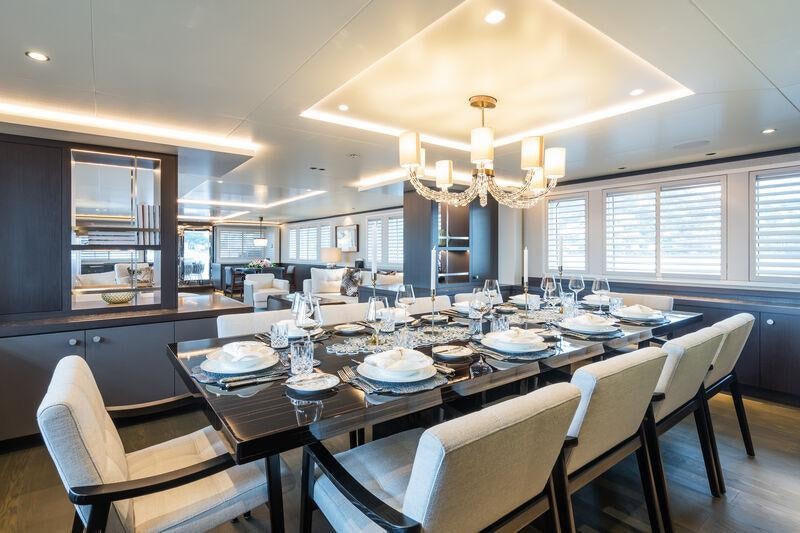 a large dining room with white chairs aboard EMERALD Yacht for Sale