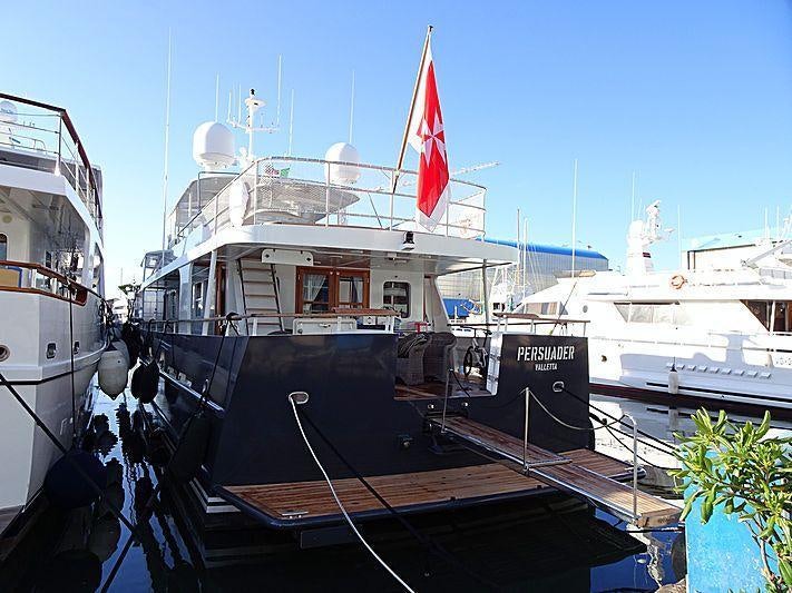 a boat docked at a pier aboard PERSUADER Yacht for Charter