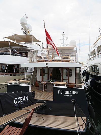 a boat with a flag on the front aboard PERSUADER Yacht for Charter