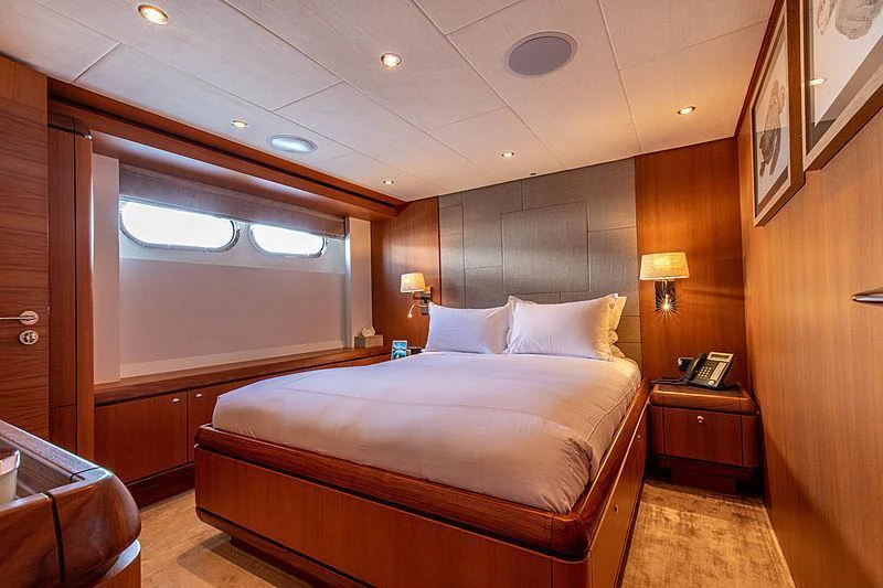 a room with a bed and a desk aboard GALENA Yacht for Charter