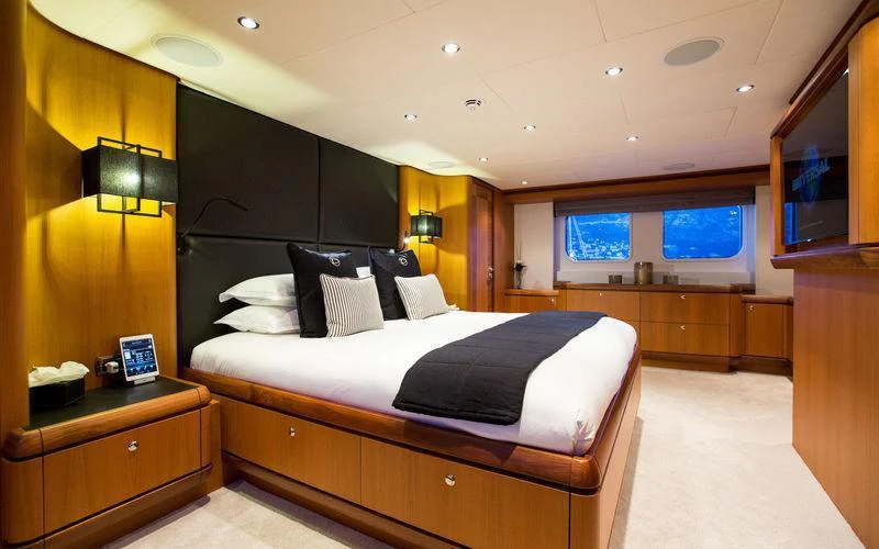 a bedroom with a bed and a desk aboard GALENA Yacht for Charter