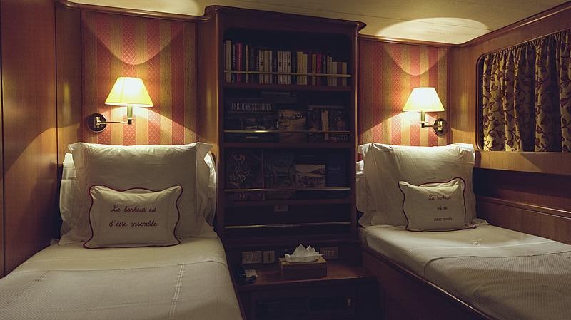 a room with a book shelf and a bed aboard FREEMONT Yacht for Charter
