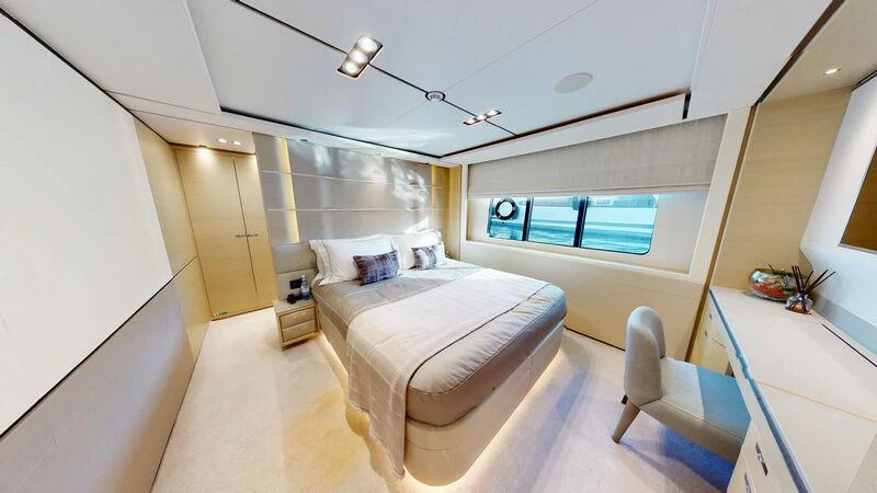 a bedroom with a bed and a chair aboard HALLELUJAH Yacht for Charter