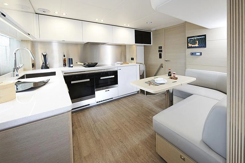 a kitchen with a sink and a bed aboard HALLELUJAH Yacht for Charter