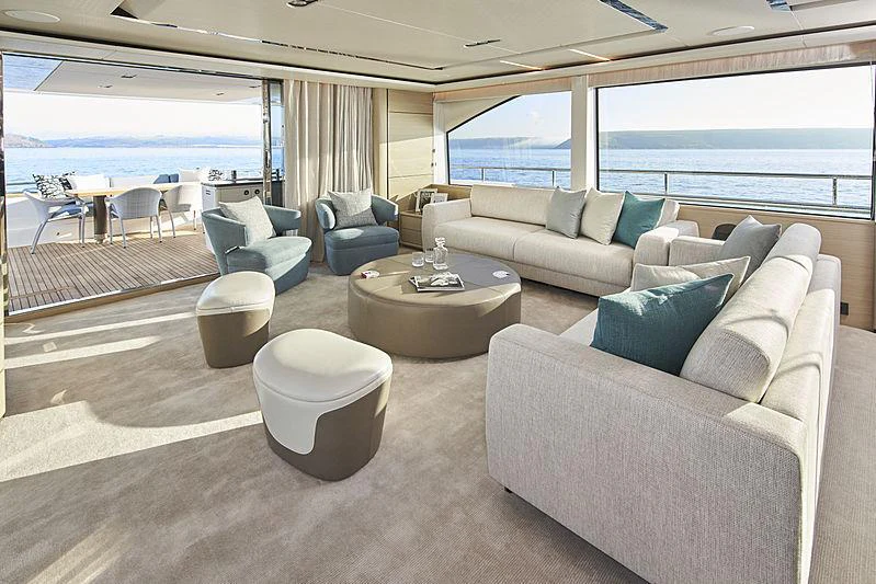 a living room with a large window aboard HALLELUJAH Yacht for Charter