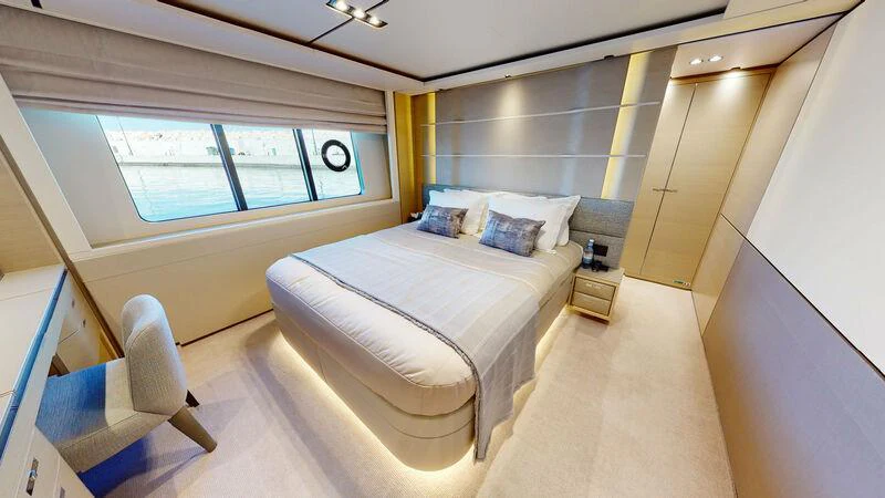 a bedroom with a bed and a window aboard HALLELUJAH Yacht for Charter