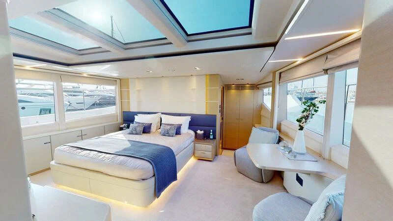 a bedroom with a bed and a table aboard HALLELUJAH Yacht for Charter