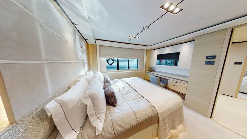 a room with a bed and a tv on the wall aboard HALLELUJAH Yacht for Charter