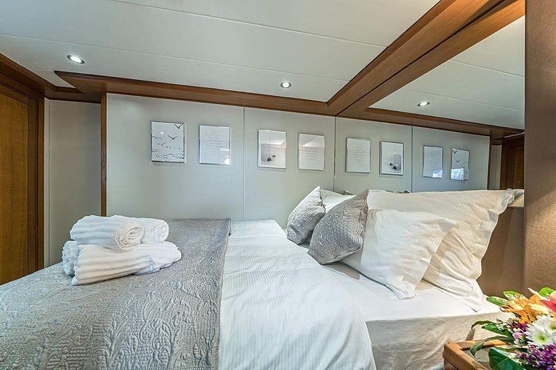 a bed with white sheets aboard SAN LIMI Yacht for Charter