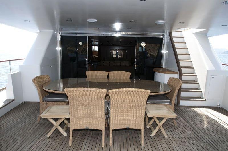 a room with a table and chairs aboard SAN LIMI Yacht for Charter