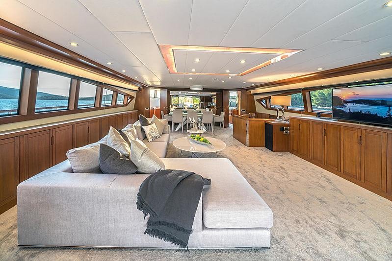 a large room with a couch and a table aboard SAN LIMI Yacht for Charter