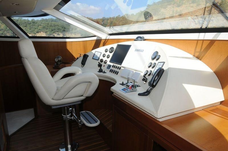 a white table with a white table and chairs on it aboard SAN LIMI Yacht for Charter