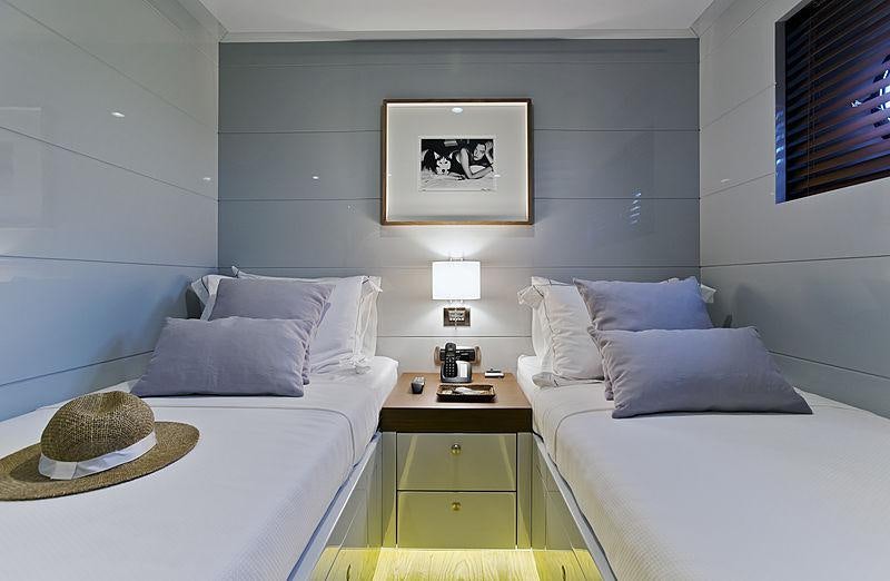 a room with a bed and a table aboard ONLY NOW Yacht for Charter