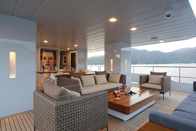 a living room with a large balcony aboard ONLY NOW Yacht for Charter