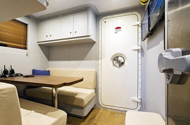 a room with a table and a large machine aboard ONLY NOW Yacht for Charter