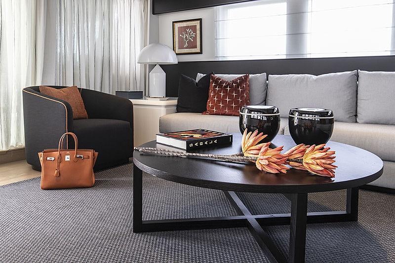 a living room with a coffee table and couches aboard PROJECT STEEL Yacht for Charter