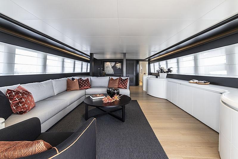 a living room with a large window aboard PROJECT STEEL Yacht for Charter