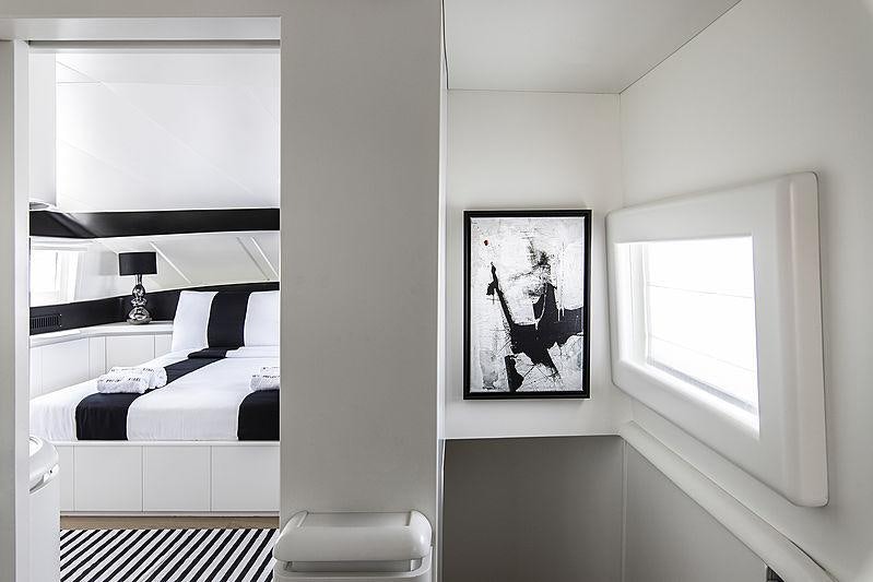a bedroom with a picture on the wall aboard PROJECT STEEL Yacht for Charter