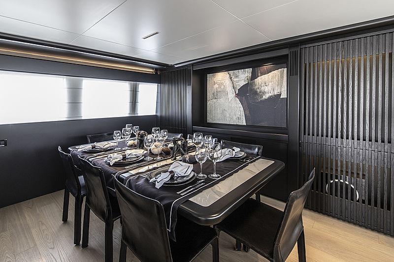 a dining table in a room aboard PROJECT STEEL Yacht for Charter
