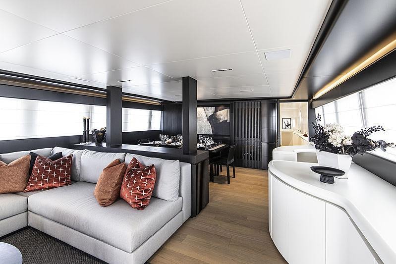 a living room with a large window aboard PROJECT STEEL Yacht for Charter