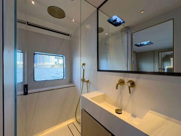 a bathroom with a large mirror aboard BUNDALONG Yacht for Charter
