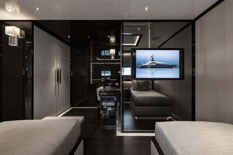 a room with a tv and a bed aboard RESILIENCE Yacht for Charter