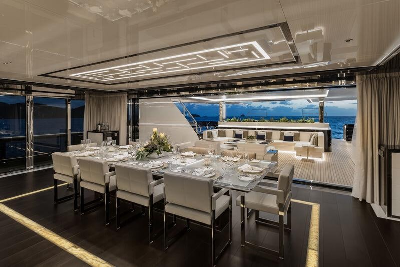 a large room with tables and chairs aboard RESILIENCE Yacht for Charter