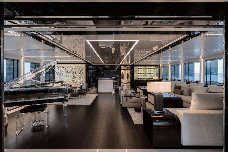 a large room with couches and a table aboard RESILIENCE Yacht for Charter