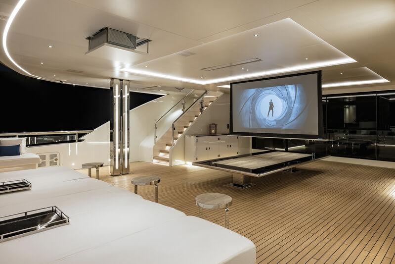 a large room with a tv and a bed aboard RESILIENCE Yacht for Charter