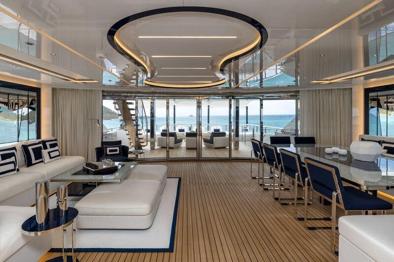 inside of a building with tables and chairs aboard RESILIENCE Yacht for Charter