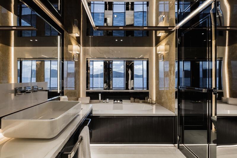 a large bathroom with a large tub aboard RESILIENCE Yacht for Charter
