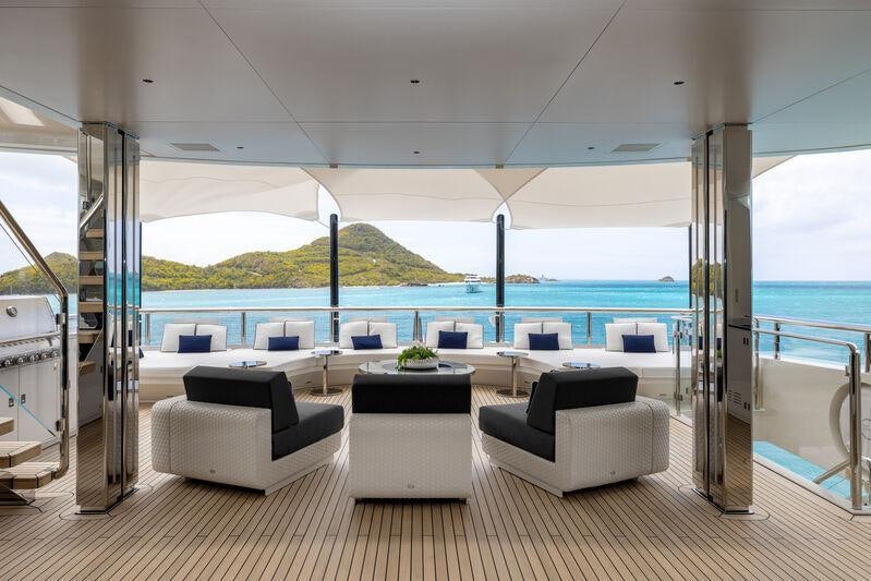 a room with a view of the ocean and a large pool aboard RESILIENCE Yacht for Charter