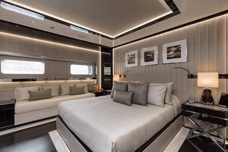 a room with a bed and a couch aboard RESILIENCE Yacht for Charter