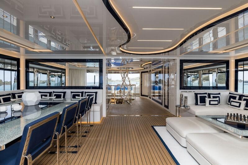 inside of a building with tables and chairs aboard RESILIENCE Yacht for Charter