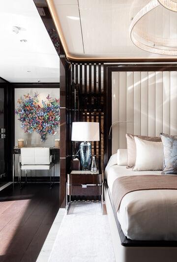 a bedroom with a large mirror aboard RESILIENCE Yacht for Charter