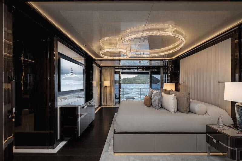 a large bedroom with a large mirror aboard RESILIENCE Yacht for Charter