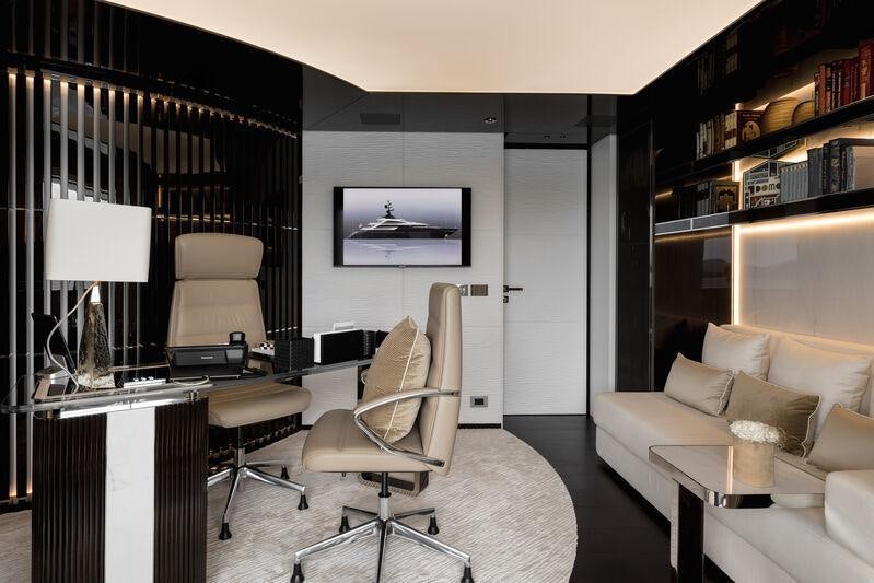 a living room with a white couch and a black curtain aboard RESILIENCE Yacht for Charter