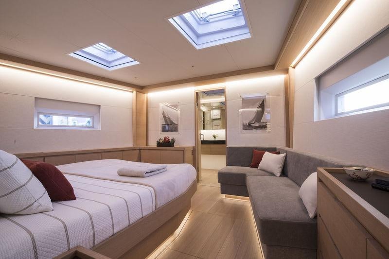 a bedroom with a bed and a couch aboard KIWAYU Yacht for Charter