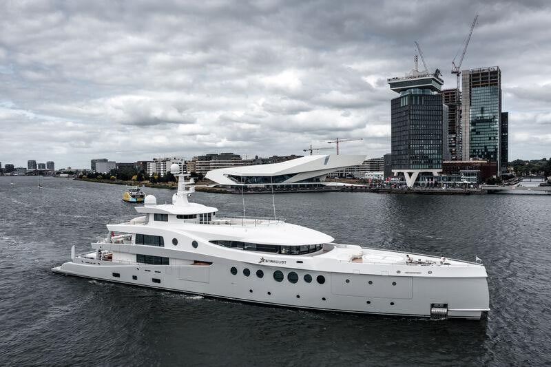 a large white boat in the water aboard STARDUST Yacht for Sale