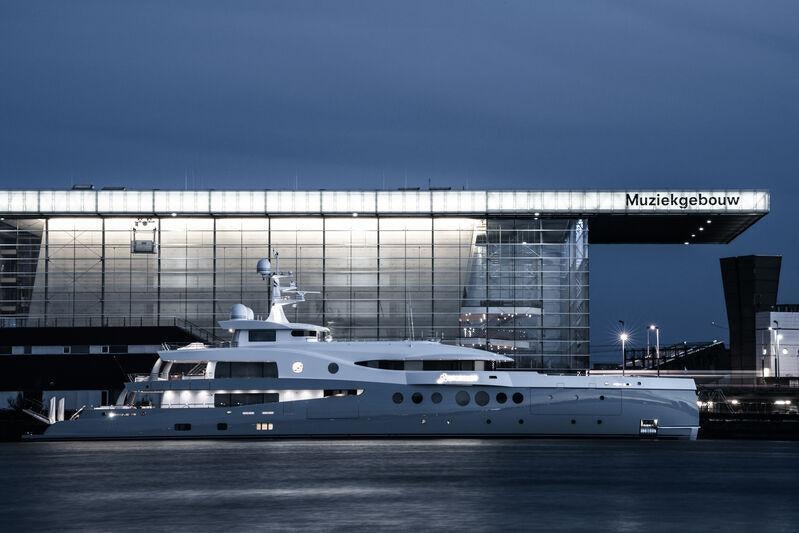 a large cruise ship in front of a large building aboard STARDUST Yacht for Sale