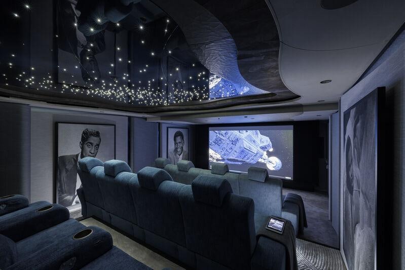 a room with a couch and a television aboard AHPO Yacht for Charter