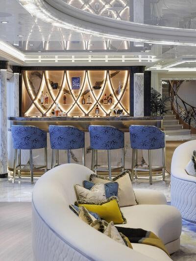 a room with a couch and chairs aboard AHPO Yacht for Charter