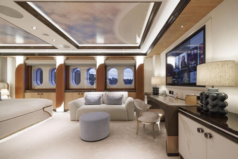 a room with a couch and a tv aboard AHPO Yacht for Charter