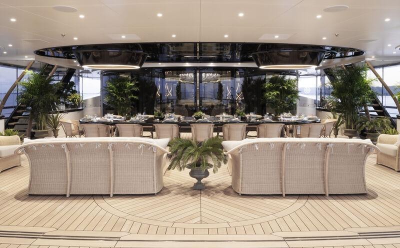 a room with a table and chairs aboard AHPO Yacht for Charter